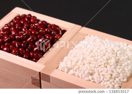 A masu (wooden measuring box) with a black background overflowing with red beans and glutinous rice. A masu (wooden measuring box) with a black background overflowing with red beans and glutinous rice. 138853017