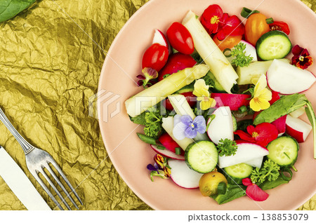 Colorful Vegetable Salad with Asparagus, Radishes and Edible Flowers on a Plate Colorful Vegetable Salad with Asparagus, Radishes and Edible Flowers on a Plate 138853079