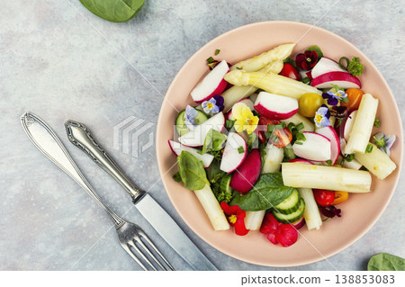 Colorful Vegetable Salad with Asparagus, Radishes and Edible Flowers on a Plate Colorful Vegetable Salad with Asparagus, Radishes and Edible Flowers on a Plate 138853083