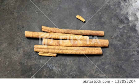 Aromatic Cinnamon Sticks and Broken Bark on Dark Rustic Background Aromatic Cinnamon Sticks and Broken Bark on Dark Rustic Background 138853204