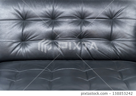 Black Quilted Leather Sofa Corner Close Up with Soft Cushioned Texture Details 138853242