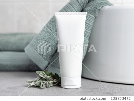 White cream tube mockup near leaves and sage green towel in bathroom, unbranded cosmetic White cream tube mockup near leaves and sage green towel in bathroom, unbranded cosmetic 138853472