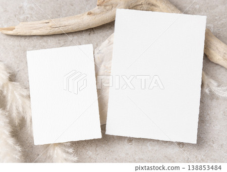 Blank wedding cards set mockup on beige stone with driftwood and pampas grass, boho mockup Blank wedding cards set mockup on beige stone with driftwood and pampas grass, boho mockup 138853484