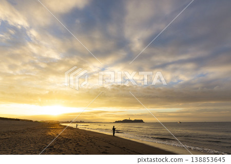 Shonan Tsujido Beach: Sunrise, Enoshima Island, and the silhouette of a fisherman. 138853645