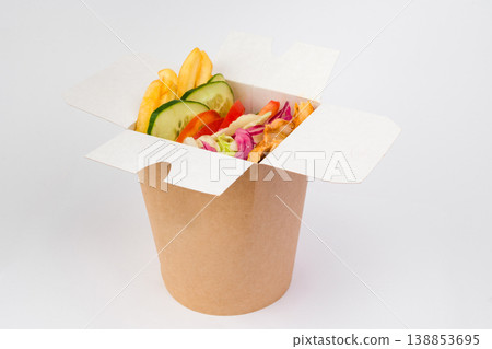 Colorful and appetizing kebab box filled with fresh vegetables, crispy fries, and savory meat pieces presented in a stylish takeout container Colorful and appetizing kebab box filled with fresh vegetables, crispy fries, and savory meat pieces presented in a stylish takeout container 138853695