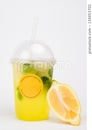 Refreshing citrus drink served in a clear cup with a lemon slice and mint leaves, perfect for summer days and delightful gatherings Refreshing citrus drink served in a clear cup with a lemon slice and mint leaves, perfect for summer days and delightful gatherings 138853702