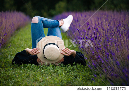 Relaxing in a lavender field, enjoying the summer sun. 138853773
