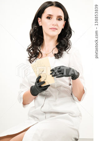 Scientist holding a research sample in a lab coat. Scientist holding a research sample in a lab coat. 138853839