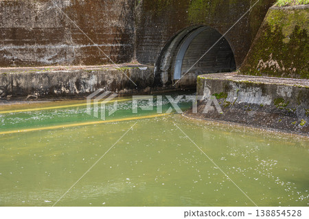 The Lake Biwa Canal, with cherry blossom petals floating on its surface, at the exit of the Moroha Tunnel, Kyoto City. The Lake Biwa Canal, with cherry blossom petals floating on its surface, at the exit of the Moroha Tunnel, Kyoto City. 138854528