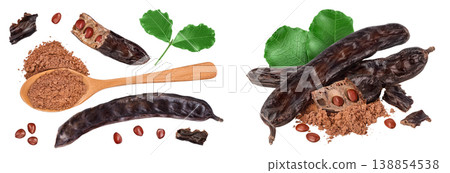 Carob pod and powder in wooden spoon isolated on white background . Top view. Flat lay Carob pod and powder in wooden spoon isolated on white background . Top view. Flat lay 138854538