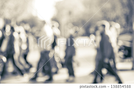Blurred people walking across urban street scene Blurred people walking across urban street scene 138854588