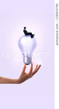 Businessman sitting on light bulb in hand representing startup funding and idea validation 138854746