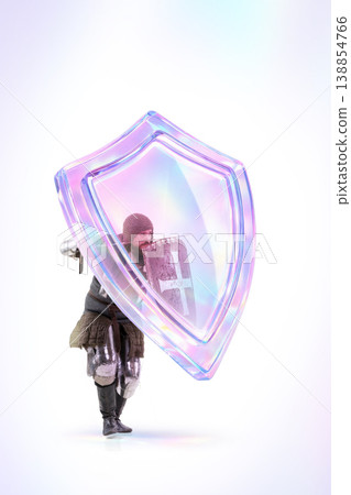 Medieval knight protected by futuristic holographic shield isolated on white background. 138854766