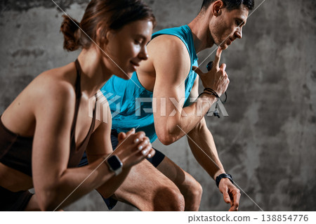 Man demonstrating breathing and pacing technique during workout session with woman. Man demonstrating breathing and pacing technique during workout session with woman. 138854776
