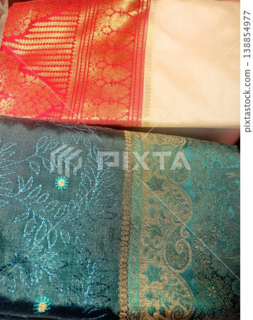 Indian sari fabric in vibrant pink and green, embroidered with gold thread. Indian sari fabric in vibrant pink and green, embroidered with gold thread. 138854977