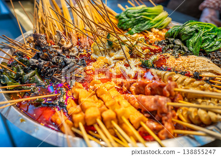 Local food and snacks including pork, Scallion Oil Noodles, intestines and seafood brochettes displayed in a popular market at night, Shanghai, China. Local food and snacks including pork, Scallion Oil Noodles, intestines and seafood brochettes displayed in a popular market at night, Shanghai, China. 138855247