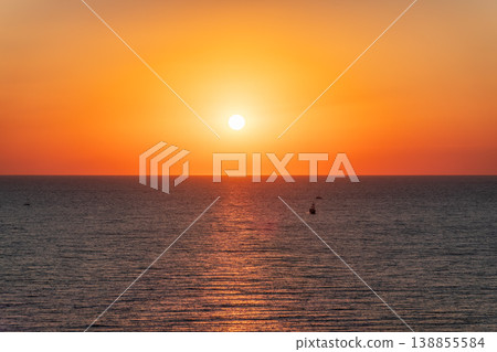 Beautiful red and orange sunrise over the sea. Beautiful red and orange sunrise over the sea. 138855584