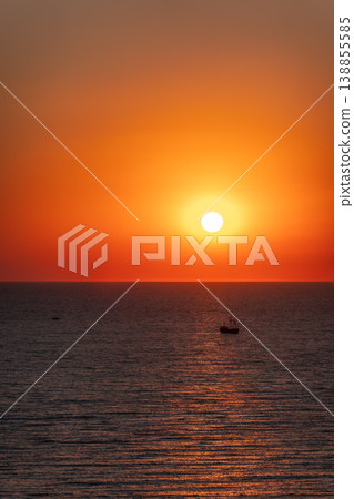 Beautiful red and orange sunrise over the sea. Beautiful red and orange sunrise over the sea. 138855585