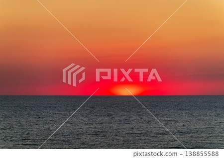 Beautiful red and orange sunrise over the sea. Beautiful red and orange sunrise over the sea. 138855588