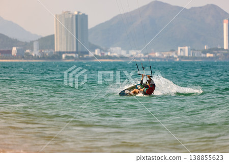 Nha Trang, Khanh Hoa, Vietnam - April 5, 2026: Kitesurfer wipeout sends dramatic spray across sea Nha Trang, Khanh Hoa, Vietnam - April 5, 2026: Kitesurfer wipeout sends dramatic spray across sea 138855623