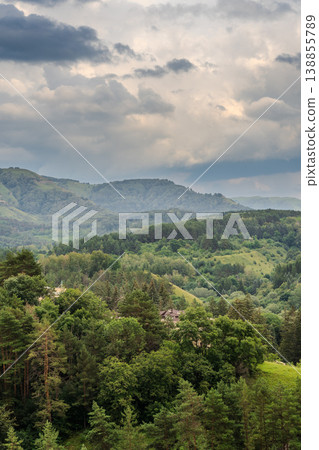 Layers of green mountains and hills in the haze during sunset. Panoramic View of Green hills and Meadow. Layers of green mountains and hills in the haze during sunset. Panoramic View of Green hills and Meadow. 138855789