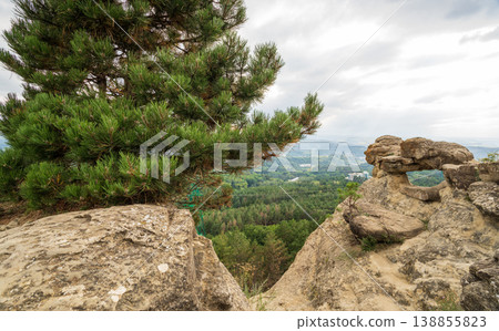 Majestic rocky cliffs and towering pine trees against blue sky. Majestic rocky cliffs and towering pine trees against blue sky. 138855823