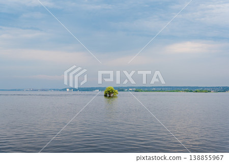 A small island in the middle of the Volga River in the vicinity of Kazan on a cloudy day. Tatarstan, Russia. A small island in the middle of the Volga River in the vicinity of Kazan on a cloudy day. Tatarstan, Russia. 138855967