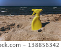 Yellow sunscreen spray bottle on dry sand beach Summer sun protection concept minimal cosmetic product mockup with copy space 138856342