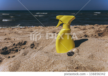 Yellow sunscreen spray bottle on dry sand beach Summer sun protection concept minimal cosmetic product mockup with copy space Yellow sunscreen spray bottle on dry sand beach Summer sun protection concept minimal cosmetic product mockup with copy space 138856342