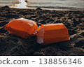 Inflatable armbands on sandy beach Child water safety concept swimming protection and learning basics of safe behavior near sea 138856346