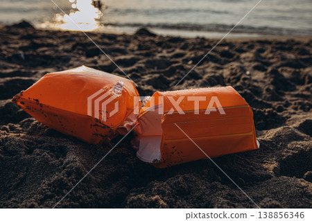 Inflatable armbands on sandy beach Child water safety concept swimming protection and learning basics of safe behavior near sea Inflatable armbands on sandy beach Child water safety concept swimming protection and learning basics of safe behavior near sea 138856346