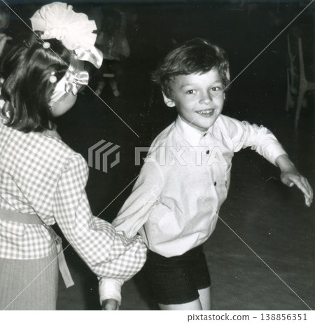 Two children dancing together at school event 1960s Two children dancing together at school event 1960s 138856351