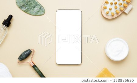 Smartphone display showcasing skincare products arranged with marble face roller, gua sha, wooden body brush, facial cream, and serum Smartphone display showcasing skincare products arranged with marble face roller, gua sha, wooden body brush, facial cream, and serum 138856650