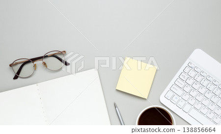 Organized workspace featuring keyboard, glasses, notebook, and stationery supporting productive workflow Organized workspace featuring keyboard, glasses, notebook, and stationery supporting productive workflow 138856664