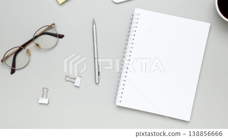 Calm and focused workspace featuring coffee cup, glasses, and notebook in minimalist setup 138856666