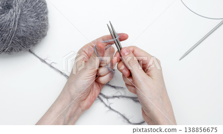 Woman using knitting needles to craft handmade fabric Woman using knitting needles to craft handmade fabric 138856675