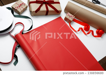 Gift wrapping paper spread on table prepared for present packaging process 138856680