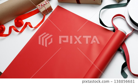 Wrapping paper laid out on table ready for gift packaging process Wrapping paper laid out on table ready for gift packaging process 138856681