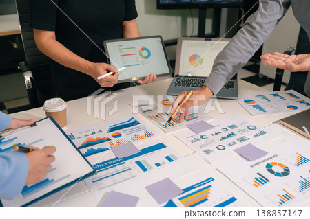 Business consultants discuss tax, merger strategy and restructuring in modern office. Business consultants discuss tax, merger strategy and restructuring in modern office. 138857147