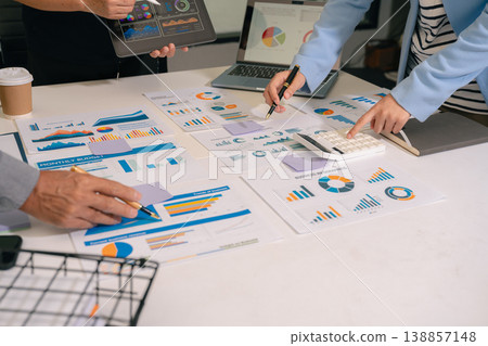 Teamwork process, Business team using a calculator to calculate the numbers of statistic business profits growth rate on documents graph data, desk in the office. Teamwork process, Business team using a calculator to calculate the numbers of statistic business profits growth rate on documents graph data, desk in the office. 138857148