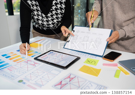 Creative digital development agency. developer team brainstorming on their project with laptop, smartphone and digital tablet. Creative digital development agency. developer team brainstorming on their project with laptop, smartphone and digital tablet. 138857154