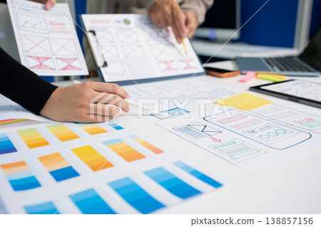 Creative digital development agency. developer team brainstorming on their project with laptop, smartphone and digital tablet. Creative digital development agency. developer team brainstorming on their project with laptop, smartphone and digital tablet. 138857156