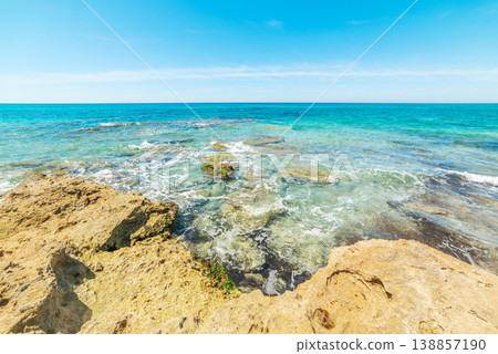 Rocks and turquoise sea in San Giovanni di Sinis beach. Rocks and turquoise sea in San Giovanni di Sinis beach. 138857190