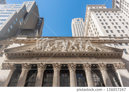 Front view of New York Stock Exchange under a clear sky. Front view of New York Stock Exchange under a clear sky. 138857267