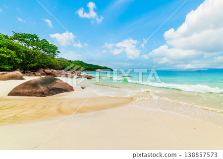 White sand and rocks in a tropical beach on a sunny day 138857573