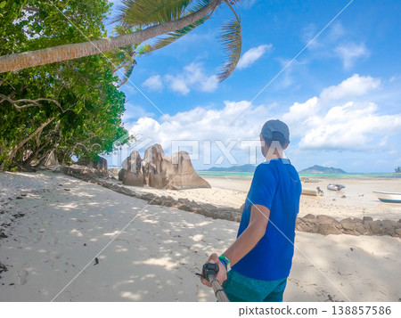 Man taking a selfie from behind in a beach Man taking a selfie from behind in a beach 138857586