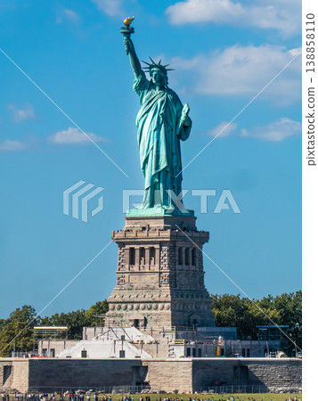 World famous Statue of Liberty under a blue sky with white clouds World famous Statue of Liberty under a blue sky with white clouds 138858110