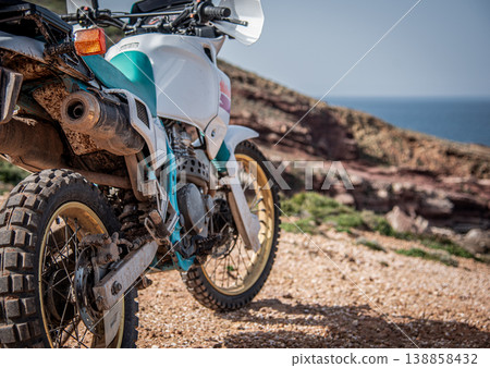 Dirty adventure motorcycle parked by the sea 138858432