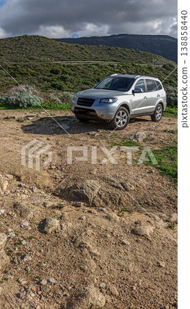 Vertical view of a 4x4 car parked on rough terrain Vertical view of a 4x4 car parked on rough terrain 138858440