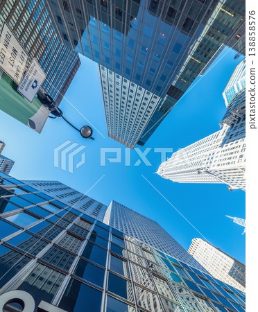 Modern skyscrapers in Manhattan seen from below on a sunny day Modern skyscrapers in Manhattan seen from below on a sunny day 138858576